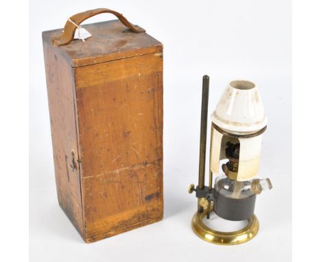A wooden cased microscope oil lamp with white porcelain shade, clear glass reservoir and brass frame, height 24.5cm.