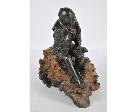 A good and large Japanese Meiji period bronze figure of a seated peasant smoking a pipe and mounted on an unusual carved and 