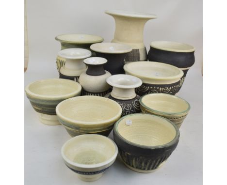 PATRICK OATES; a collection of thirteen stoneware planters and vases, the tallest of baluster form with flared rim, height 39