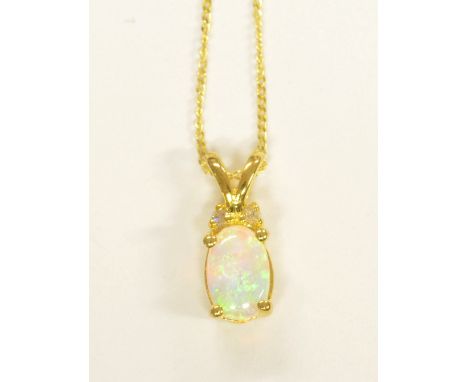 A 9ct yellow gold and oval opal pendant supported on a fine link chain.