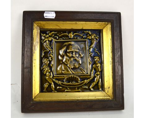 A late Victorian relief moulded square sectioned tile depicting a portrait of Longfellow, 15 x 15cm, framed.