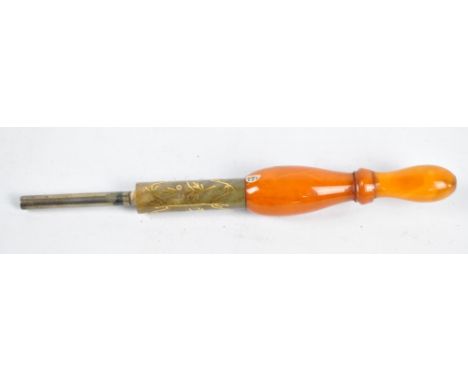 An unusual opium pipe mouthpiece with turned ivory end section and gold inlaid hardstone central barrel, length 21cm. CONDITI