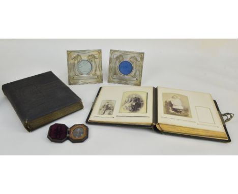 Two early to mid-19th century photograph albums with pressed decorated covers, containing various portrait photographs within
