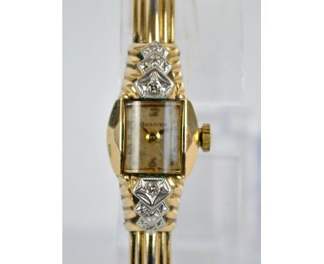 BULOVA; a 1950s 10ct gold filled manual wind lady's cocktail wristwatch with snap bangle, the rectangular dial set with Arabi