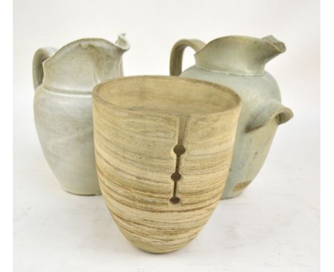 PATRICK OATES; a pair of stoneware jugs, height 30cm and an ovoid planter with pierced decoration (3).