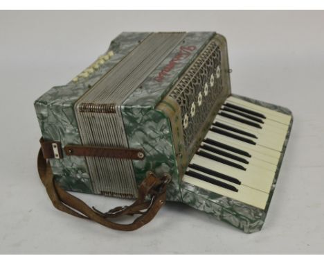A cased Vissimio piano accordion with marble effect body.