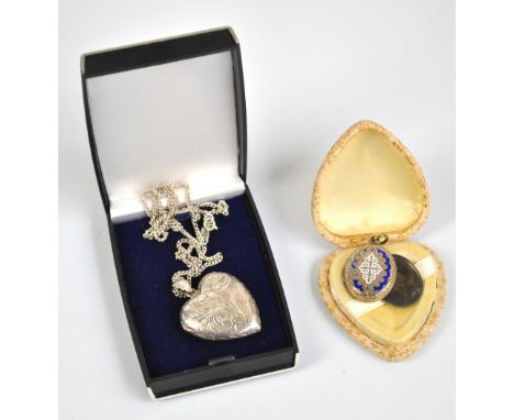 A sterling silver heart shaped locket pendant with engraved foliate scrolls on silver chain necklace, and a further oval gold