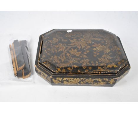 A 19th century Japanese lacquered box of rectangular form with canted corners, the detachable lid enclosing sectioned lidded 