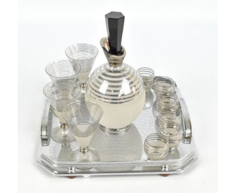 An Hungarian glass Art Deco cocktail set decorated with frosted glass and silvered stripes comprising a decanter with hexagon