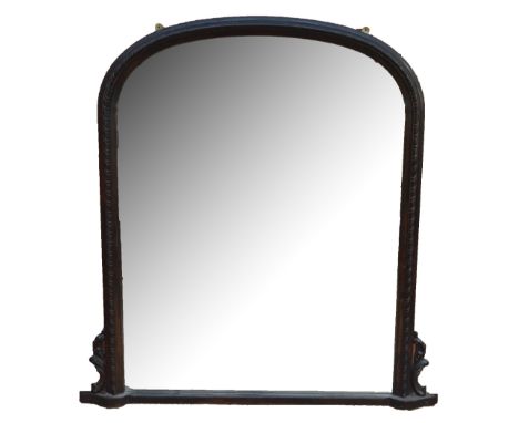 A stained oak curved overmantel mirror with fluted frame and carved supports, width 133cm, height 139cm.