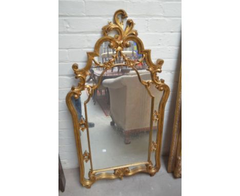 An ornate gilt mirror, 128 x 70.5cm.