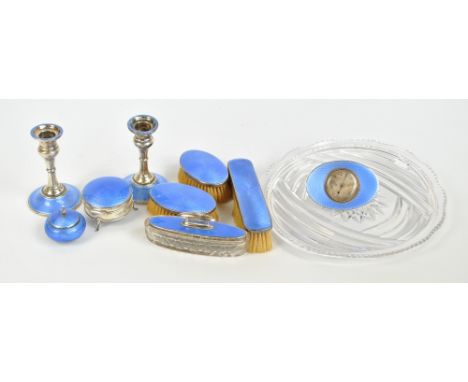 A matched George V hallmarked silver and blue guilloche enamel nine piece dressing table set, to include a trinket box and a 