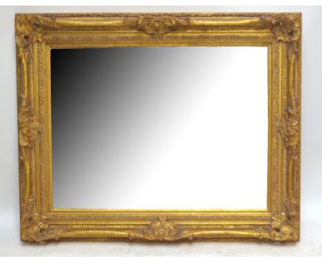 An ornate gilt mirror, 129.5 x 128cm.