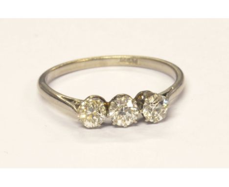 A platinum and diamond three stone ring, the round brilliant cut stones approx 1cts, colour estimate H/K, clarity estimated V