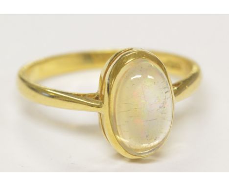 An 18ct yellow gold and water opal oval cabochon ring, size N, approx 2.8g.