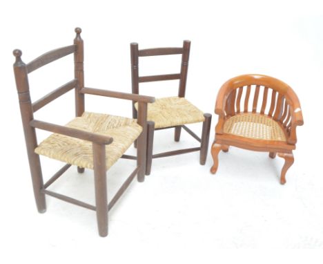 Two child's ladder back and rush seated chairs, and a further cane seated example (3).
