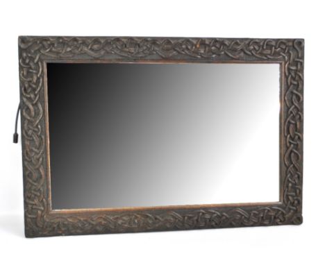A late 19th/early 20th century Macclesfield School of Carving rectangular mirror with central bevelled plate, 77 x 52cm.