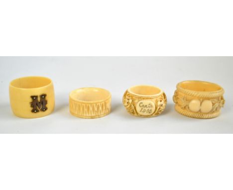 An early 20th century Chinese Canton carved ivory circular napkin ring, inscribed 'Canton 1905', a further ivorine example wi