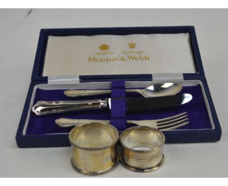 MAPPIN & WEBB; a cased Elizabeth II hallmarked silver three piece christening set comprising a spoon, fork and a silver handl