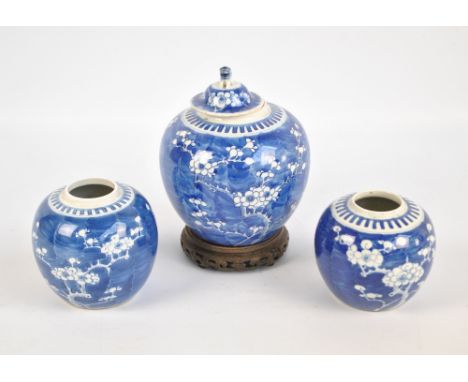 Three late 19th/early 20th century Chinese ginger jars painted in underglaze blue with blossoming prunus, each with Kangxi do