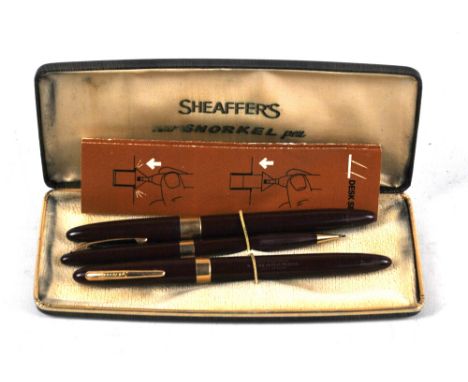 A cased set of three Sheaffer writing instruments comprising 'Snorkel' fountain pen with nib stamped '14K 5', a further fount