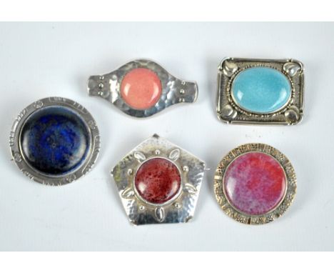 RUSKIN; five silver and white metal brooches, set with variously coloured ceramic cabochons, to include a pentagonal hammered