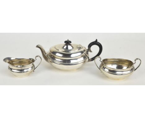 VINER'S LTD; a George V hallmarked silver three piece tea service comprising an oval teapot with band of engraved decoration,