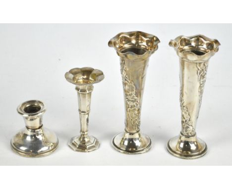 A near pair of hallmarked silver floral embossed bud vases, London other marks heavily obscured, height 14cm and a further sm