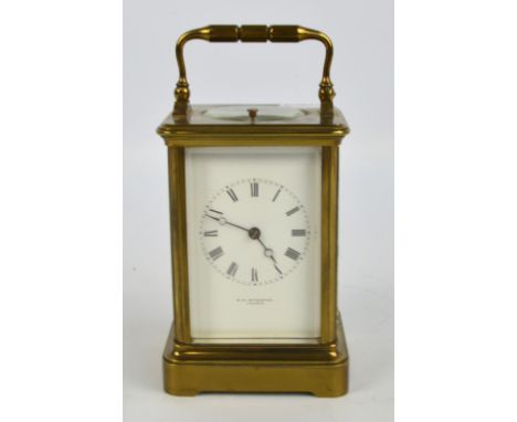 A circa 1900 brass repeating carriage clock, the rectangular dial set with circular chapter ring with Roman numerals and insc