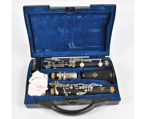 A cased French B10 clarinet marked 'Buffet a Paris Crampon & Cie' with cork grease stick and weighted cloth.