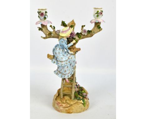 A German Ernst Bohne & Söhne porcelain twin branch candelabrum modelled as a girl seated on a ladder leaning against a flower