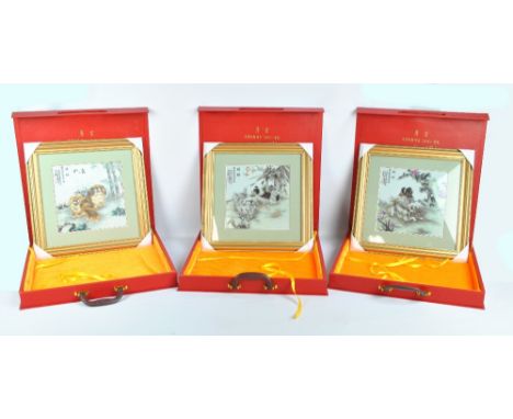 A set of three modern Chinese ceramic tiles transfer decorated with dogs and verses of script 23 x 23cm, each framed and glaz