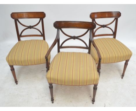 A set of eight early 19th century mahogany bar back dining chairs with padded stuff-over seats and turned tapering front legs