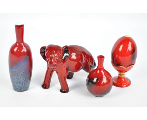 A group of Royal Doulton flambé items to include a slender veined vase no.1603, a figure of an elephant (second quality) (af)