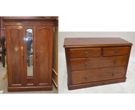 A Victorian mahogany triple wardrobe, the central mirror panel flanked by two doors opening to reveal a hanging space above t