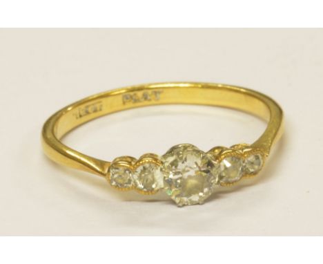 An 18ct yellow gold platinum tipped five stone graduated diamond ring, the principle stone approx 0.20cts, size R 1/2, approx