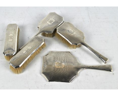 S BLANCKENSEE & SON LTD; a George V hallmarked silver five piece dressing table set comprising a mirror, a pair of hand brush