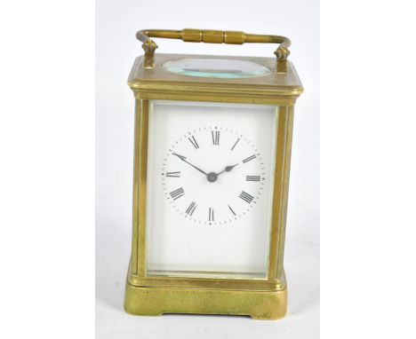 A late 19th century French brass carriage clock, the rectangular white enamel dial set with Roman numerals on bracket foot ba