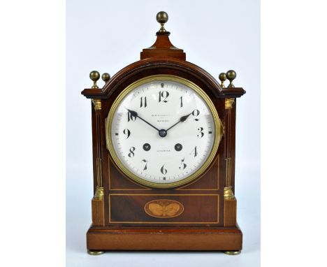 An Edwardian mahogany and inlaid mantel clock with pagoda case, circular white enamel dial set with Roman numerals inscribed 