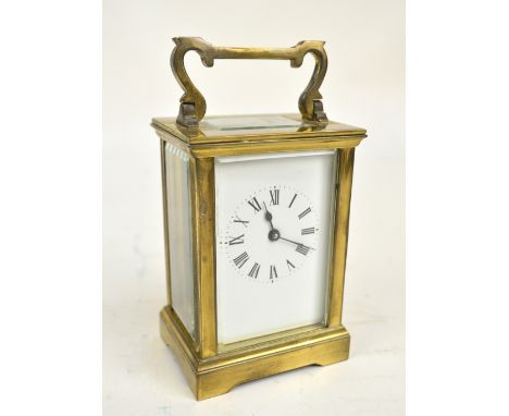 A circa 1900 French brass carriage clock, the rectangular dial with circular chapter ring set with Roman numerals, on bracket