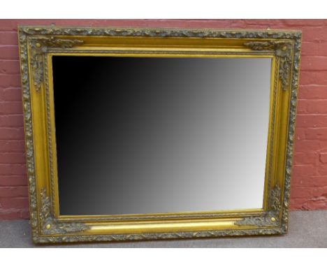 An ornate gilt rectangular mirror with bevelled glass, 152 x 123.5cm.