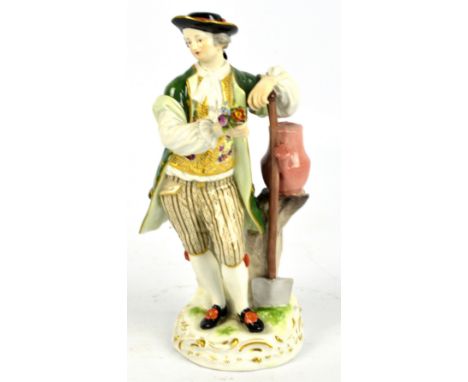 A 19th century Meissen porcelain figure of gardener leaning on a shovel beside tree stump with watering can, holding a bunch 
