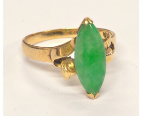 A 14ct yellow gold and jade ring in scrolling pierced setting, ring size Q, approx 3.6g.