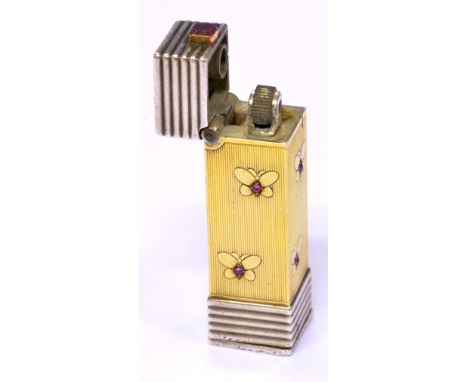 A yellow and white metal ruby set lighter of rectangular form, decorated with butterflies and with horizontal ribbed detail t