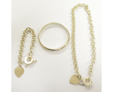 TIFFANY & CO; a silver necklace with heart shaped pendant and T-bar, matching bracelet and a hallmarked silver bangle, combin