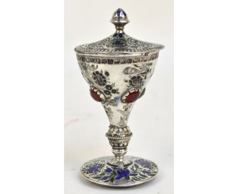 An Eastern white metal and floral enamel detailed cup and pierced cover, the bowl set with four carnelian cabochons on knoppe