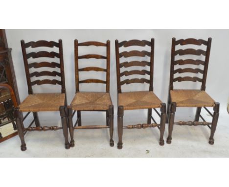 Three oak wavy ladder back dining chairs with rush seats and turned stretchers and a further example (4).