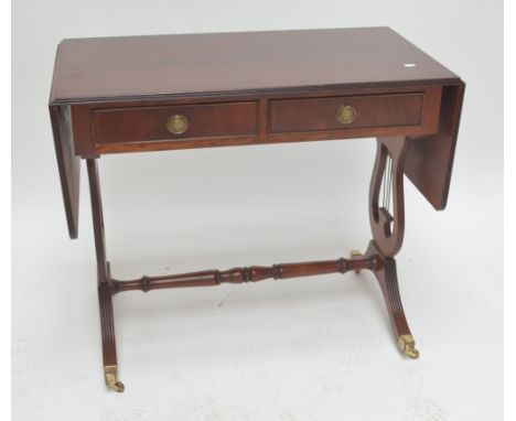 A reproduction sofa table with rectangular top, 87 x 50cm when not extended, above two drawers and lyre stretchered supports 