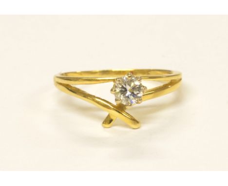 An 18ct yellow gold and single stone diamond ring, in pierced crossover setting, size L, approx 2.1g.