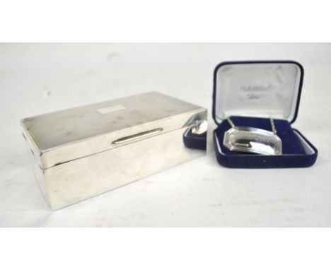 An Elizabeth hallmarked silver cigarette box of rectangular form, Birmingham 1955, width 14cm and a silver 'Whisky' decanter 